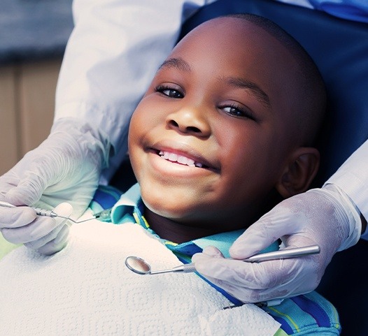Young boy receiving dental checkup and teeth cleaning