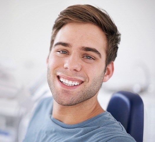 Man in dental chair for dental checkup and teeth cleaning