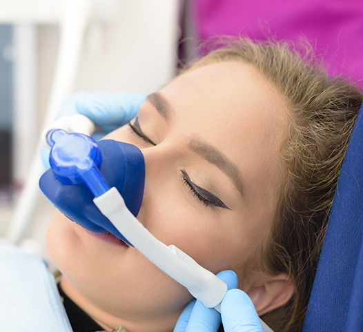 Woman with nitrous oxide dental sedation mask